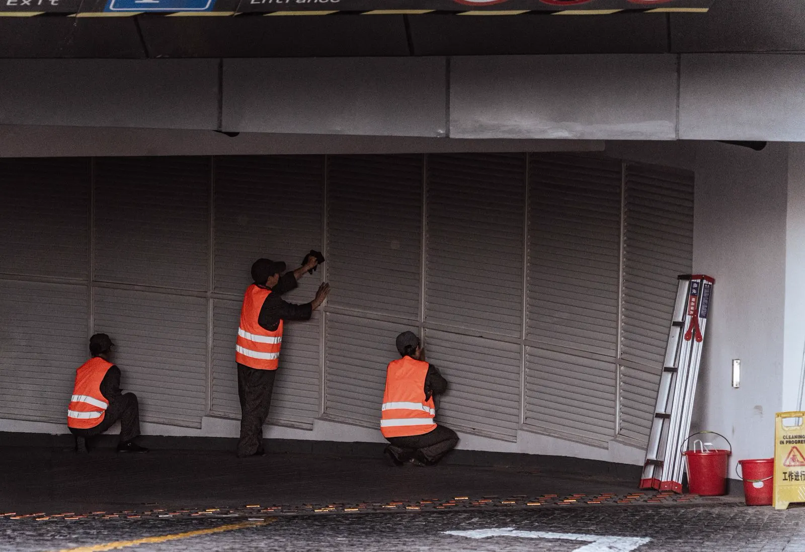 Technician repairing a commercial storefront glass door
